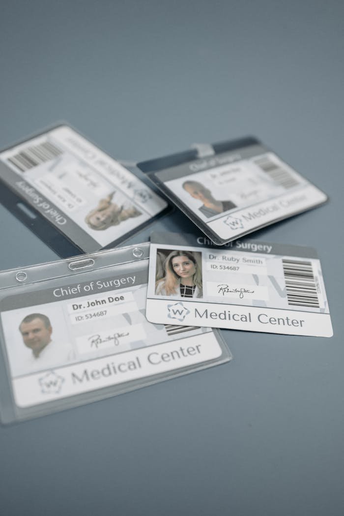 Close-up of medical ID badges featuring doctors from a healthcare center.